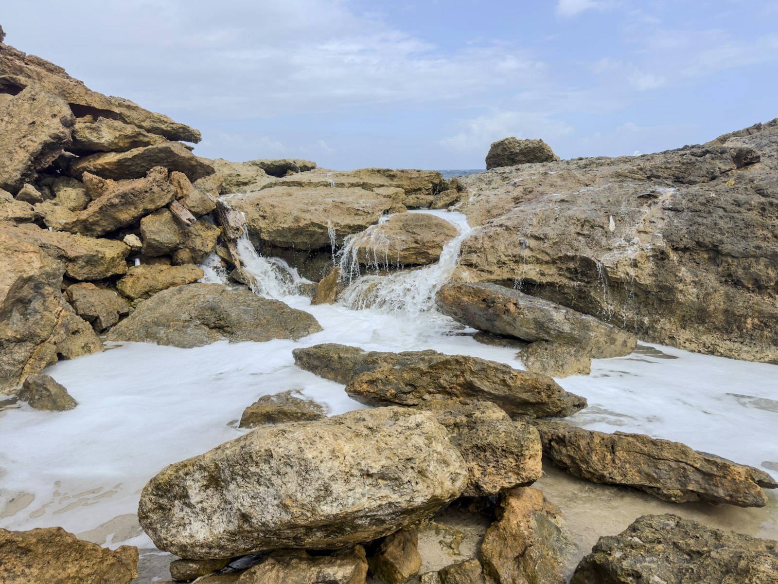 Rocky volcanic coastline near Aruba's Natural Pool